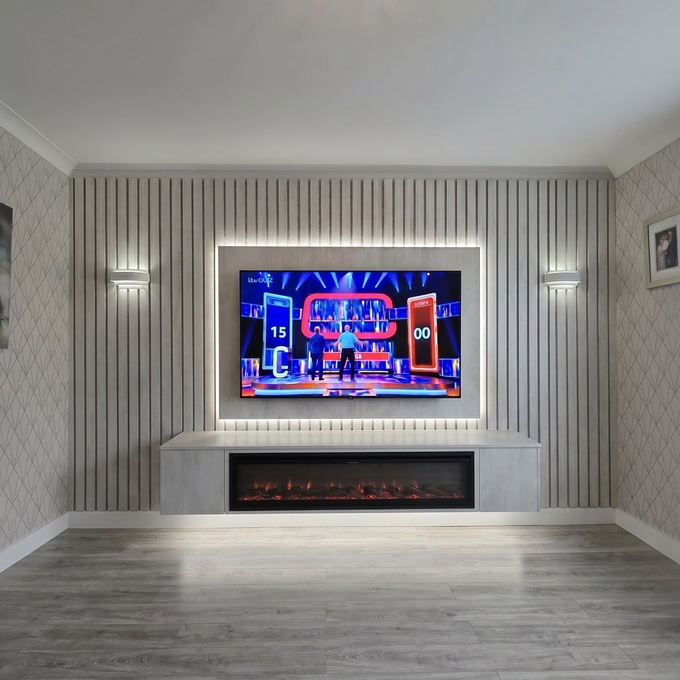 Grey slat-panel media wall with LED-lit TV surround and electric fire